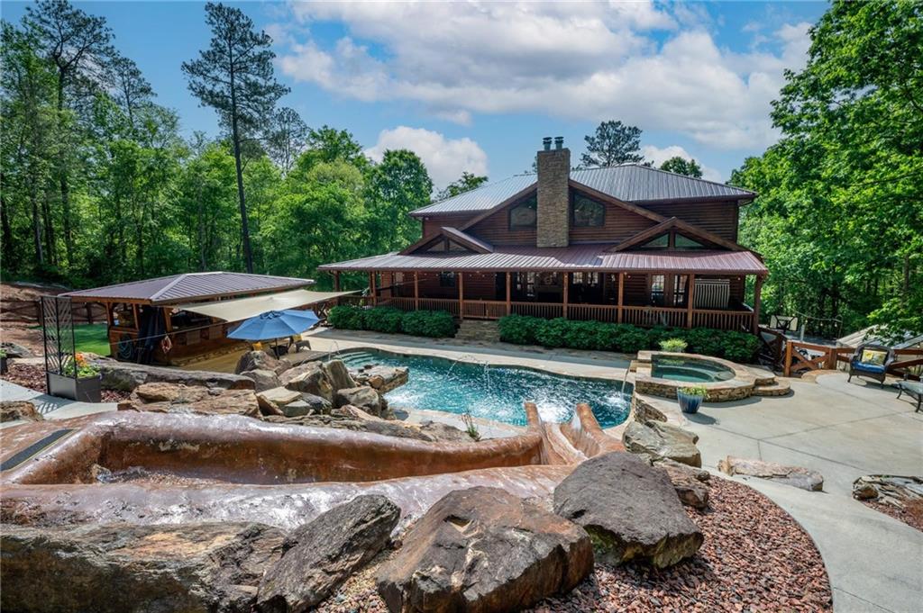 a view of a house with swimming pool and furniture