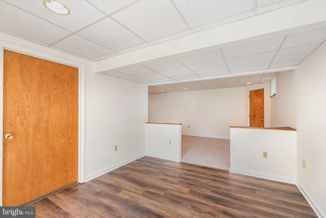 a view of a room with wooden floor and cabinet