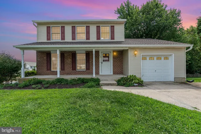 a view of a brick house with a yard