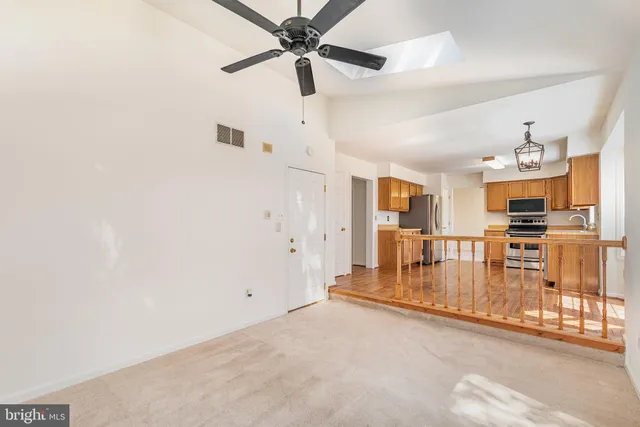 a view of a living room hardwood floor and a ceiling fan
