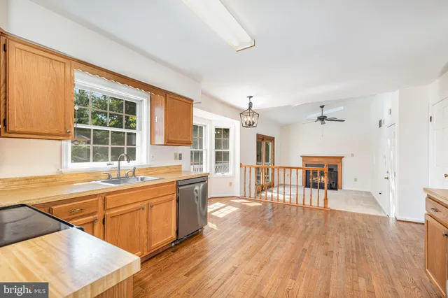 a large kitchen with a wooden floor and a sink