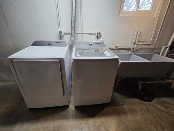 a utility room with a sink a washer and dryer