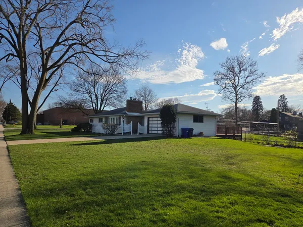 a house view with a sitting space and garden