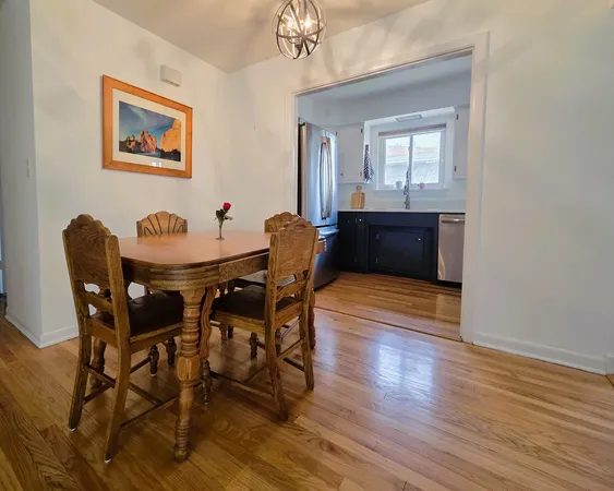 a dining room with furniture and wooden floor