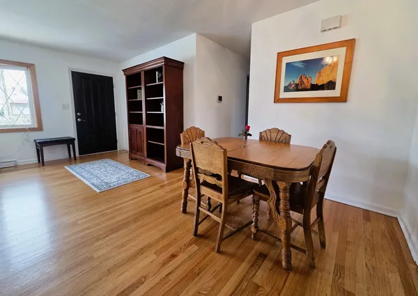 a view of a dining room with furniture and wooden floor