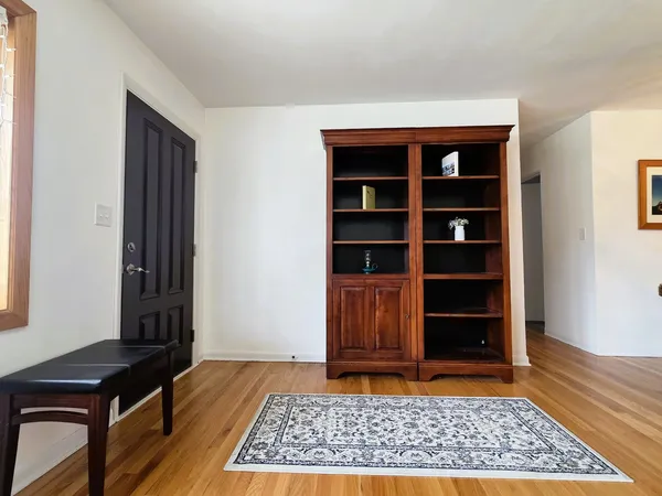 a view of a livingroom with wooden floor and closet