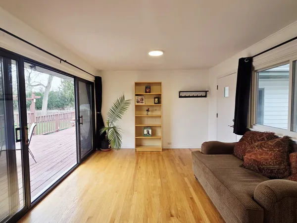 a bedroom with a bed and a large window with outer view