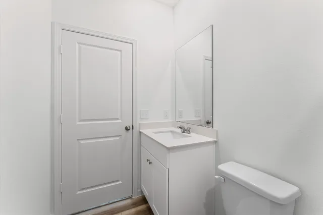 a bathroom with a toilet a sink and mirror
