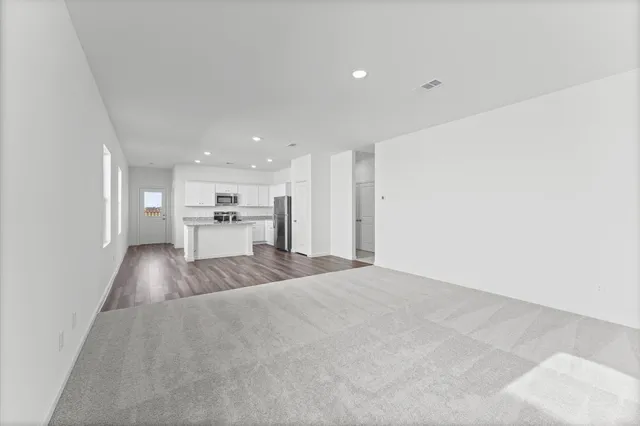 a view of kitchen with a sink and a refrigerator