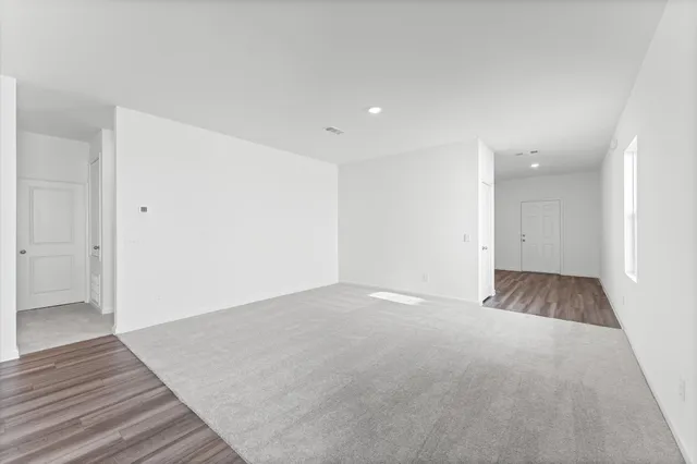 a view of an empty room and wooden floor
