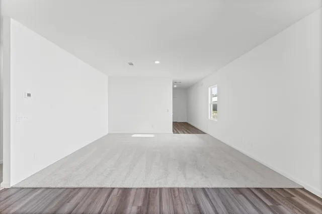 an empty room with wooden floor