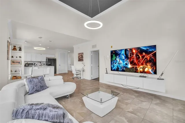 a living room with furniture a flat screen tv and a large window