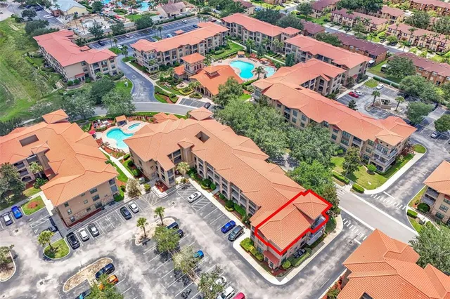 an aerial view of a house with a big yard