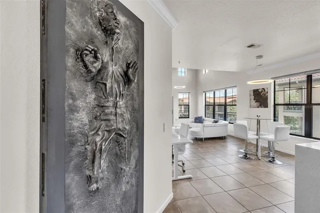 a living room with furniture and a painting on the wall