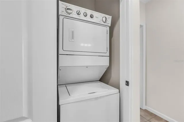 a bathroom with a granite countertop sink toilet mirror and bathtub