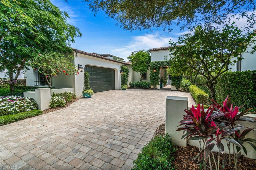 16755 Lucarno Way Naples, FL 34110 - Photo 38 of 50 a front view of a house with a yard and a garage