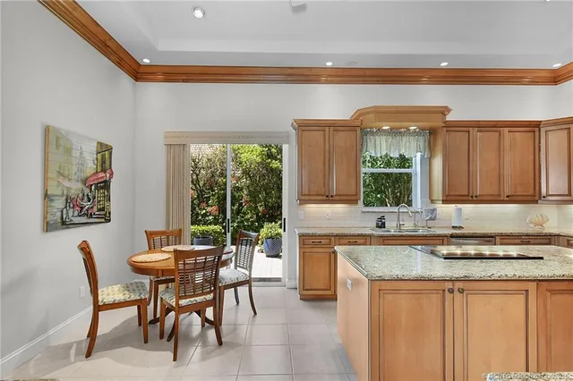 a kitchen with a table chairs sink and cabinets