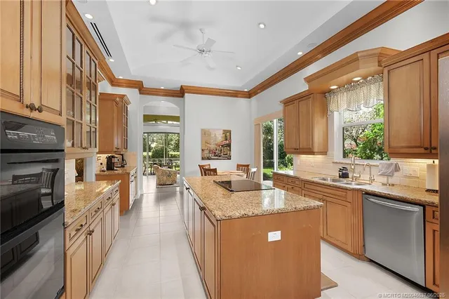 a kitchen with stainless steel appliances granite countertop a sink and a stove