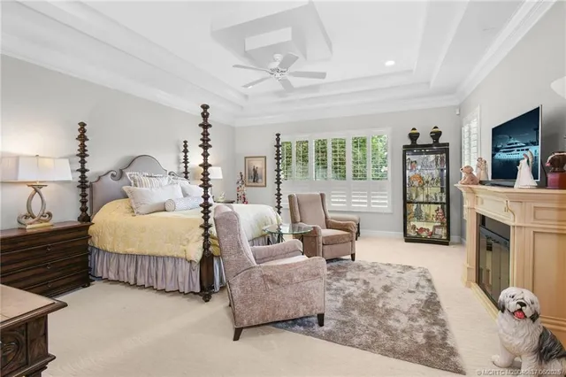 a spacious bedroom with a bed and glass door