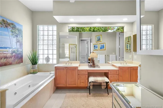 a large white kitchen with a large window and furniture