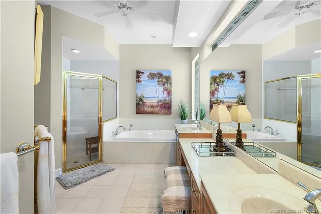 a spacious bathroom with a tub sink and mirror