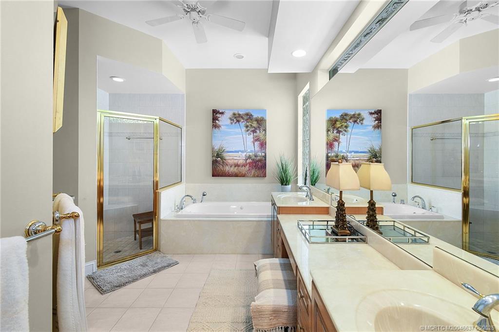 1572 Southeast Cypress Glen Way Stuart, FL 34997 - Photo 19 of 49 a spacious bathroom with a tub sink and mirror