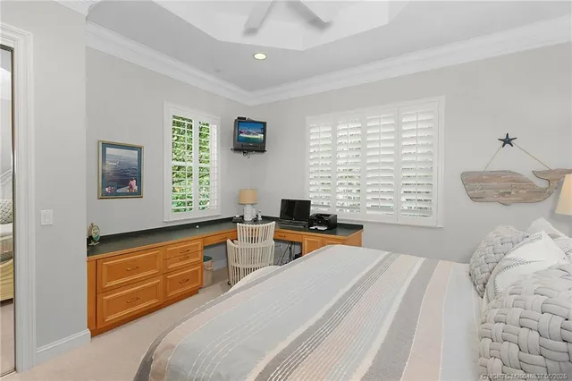 a bedroom with a bed and a window with balcony view