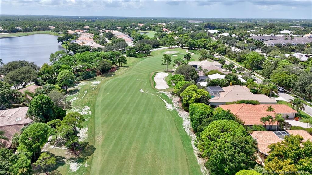 1572 Southeast Cypress Glen Way Stuart, FL 34997 - Photo 35 of 49 an aerial view of a residential houses with outdoor space and trees