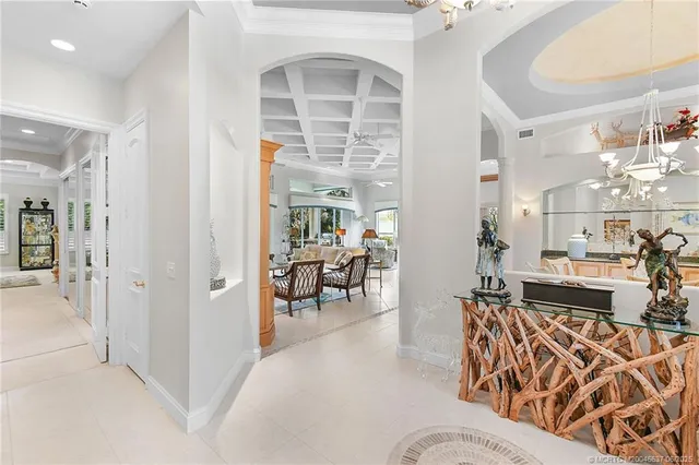 a living room with furniture and a dining table with wooden floor