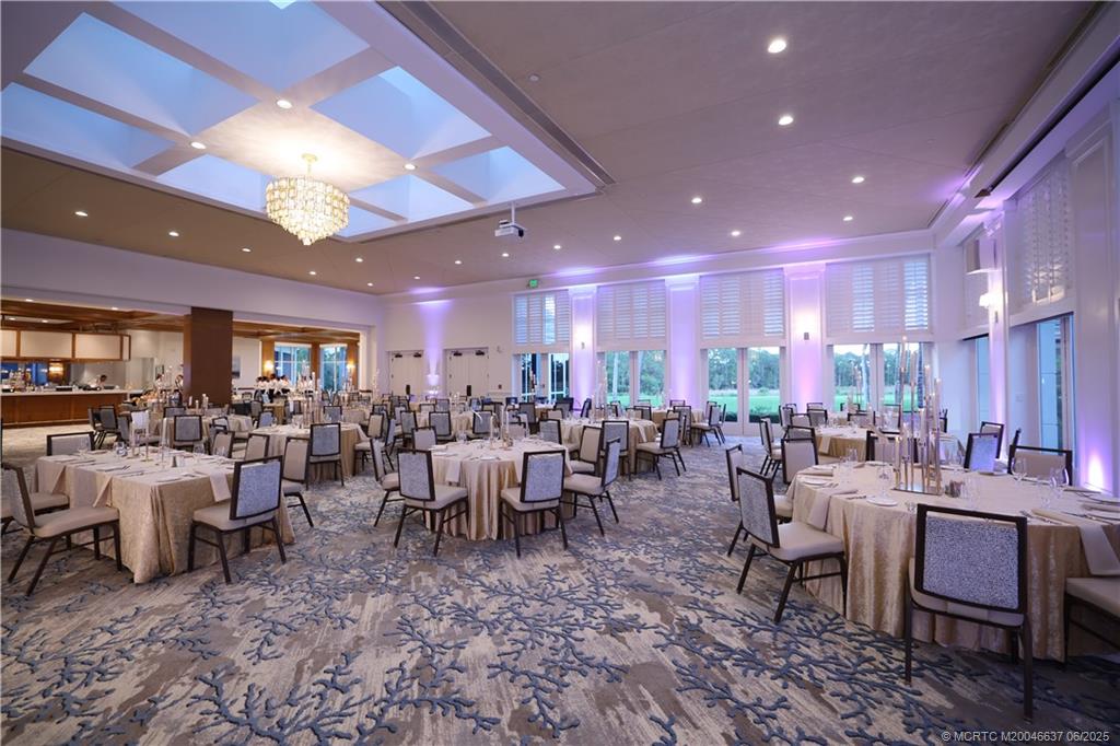 1572 Southeast Cypress Glen Way Stuart, FL 34997 - Photo 43 of 49 a room with lots of tables a large window and chairs