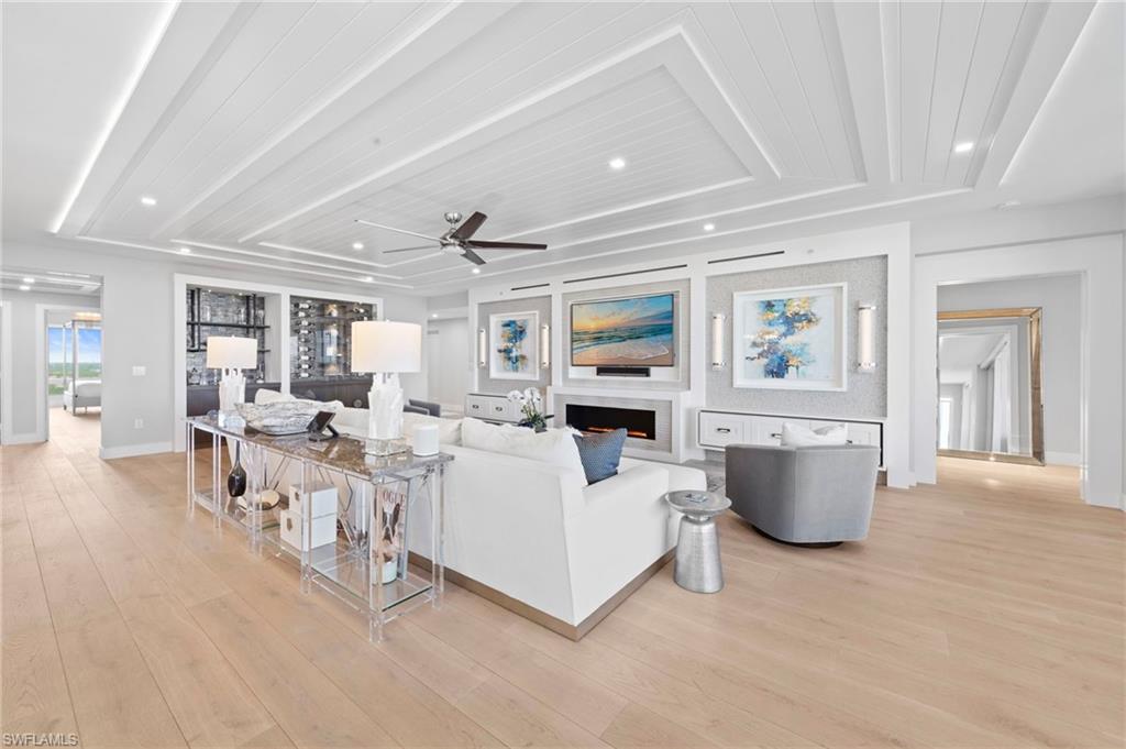 13915 Old Coast Road, Unit 1706 Naples, FL 34110 - Photo 11 of 49 a living room with furniture and a table