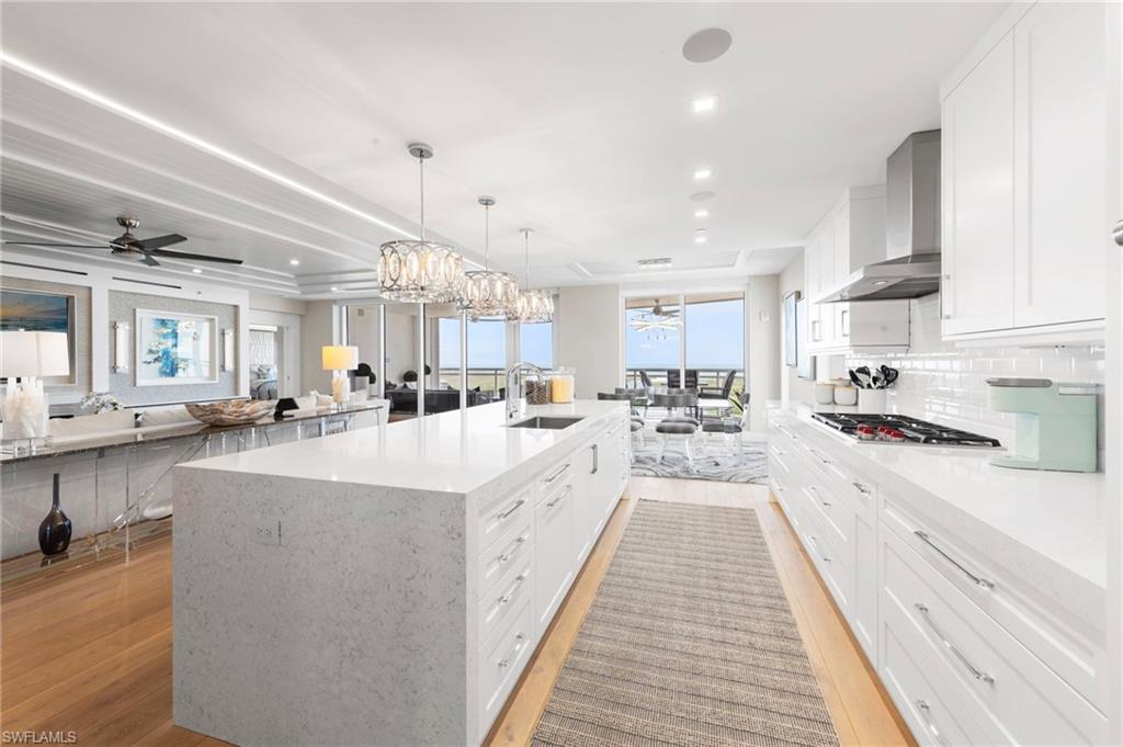 13915 Old Coast Road, Unit 1706 Naples, FL 34110 - Photo 12 of 49 a large white kitchen with lots of counter space a sink appliances and cabinets