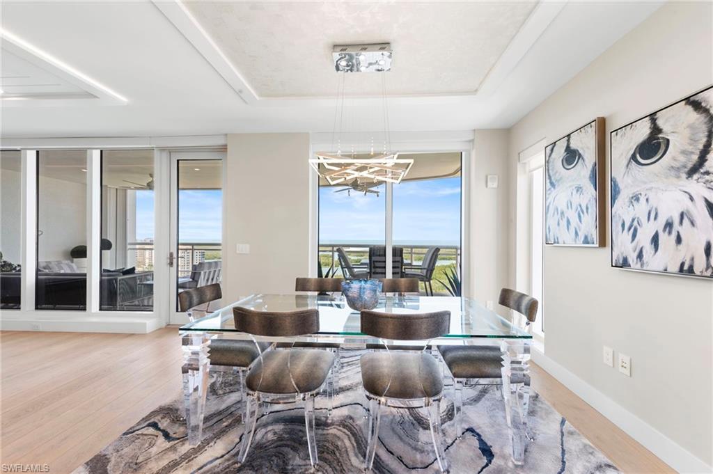13915 Old Coast Road, Unit 1706 Naples, FL 34110 - Photo 13 of 49 a living room with furniture and a large window