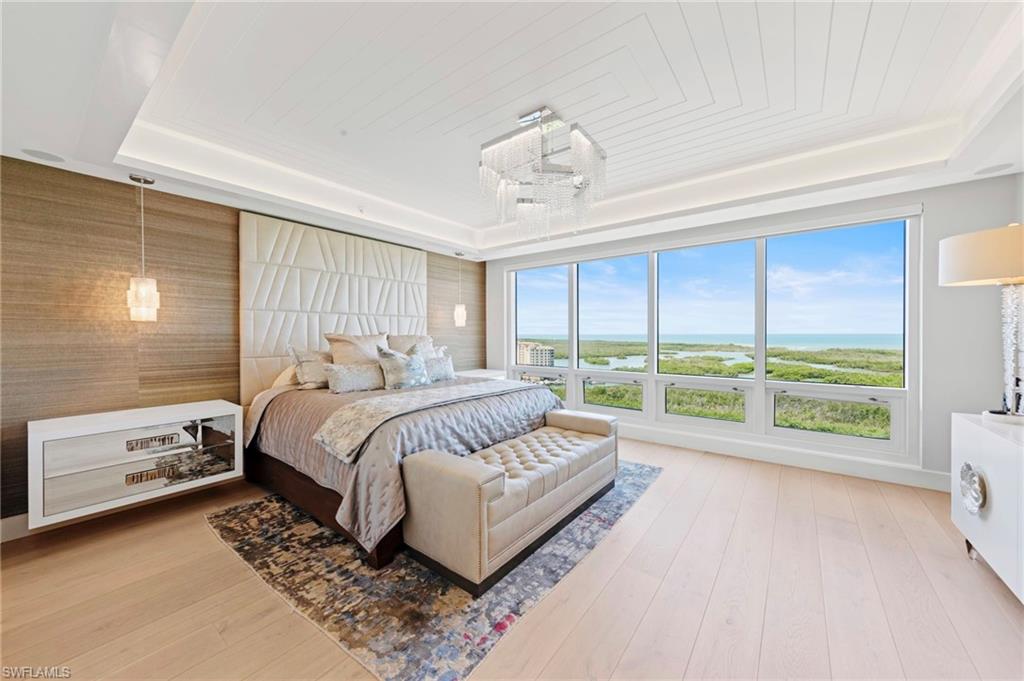 13915 Old Coast Road, Unit 1706 Naples, FL 34110 - Photo 14 of 49 a spacious bedroom with a bed and a large window