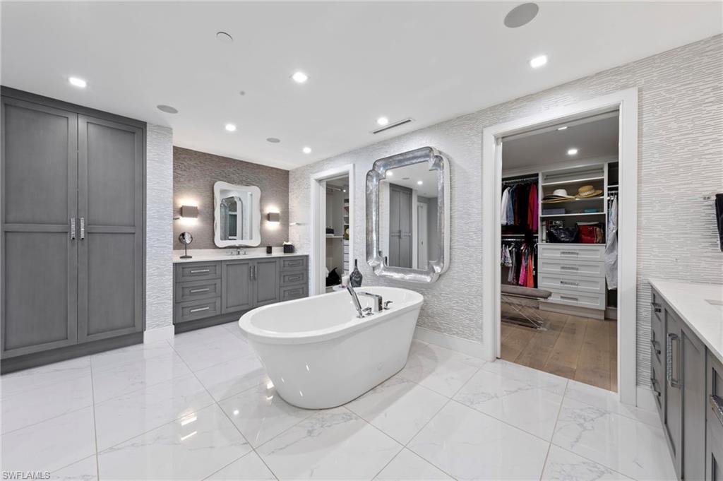 13915 Old Coast Road, Unit 1706 Naples, FL 34110 - Photo 17 of 49 a spacious bathroom with a double vanity sink and a bathtub