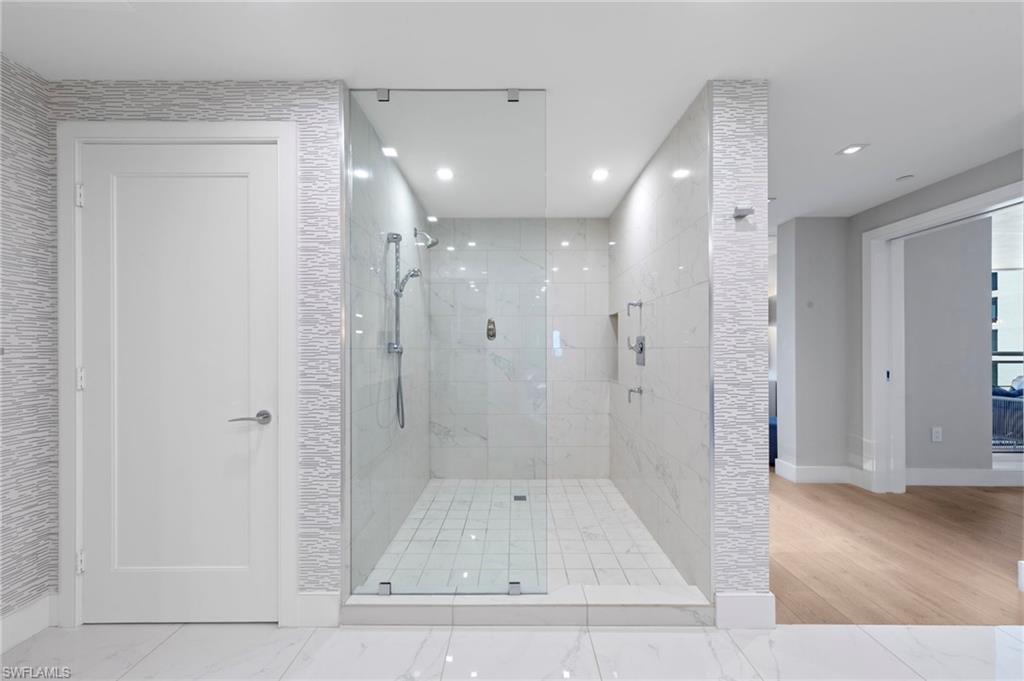 13915 Old Coast Road, Unit 1706 Naples, FL 34110 - Photo 18 of 49 a bathroom with a shower and a glass door