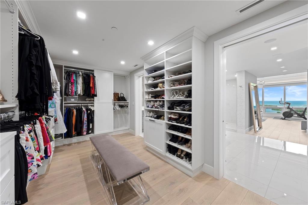 13915 Old Coast Road, Unit 1706 Naples, FL 34110 - Photo 19 of 49 a view of walk in closet with clothes and shoes