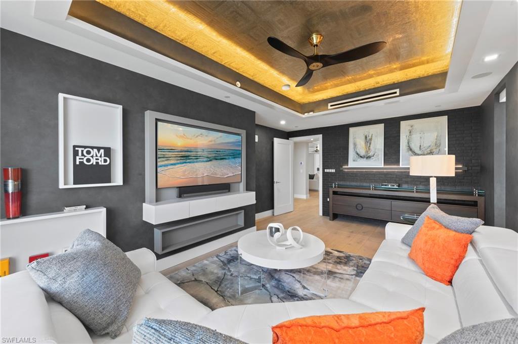 13915 Old Coast Road, Unit 1706 Naples, FL 34110 - Photo 22 of 49 a living room with furniture and a flat screen tv