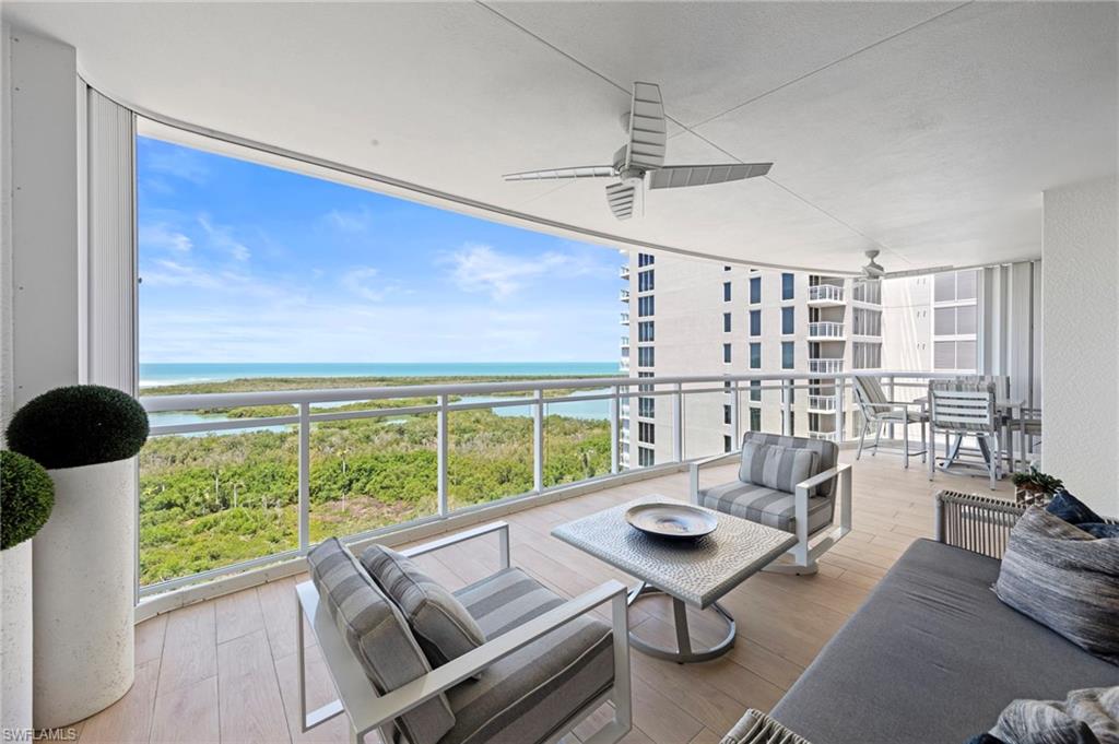 13915 Old Coast Road, Unit 1706 Naples, FL 34110 - Photo 24 of 49 a living room with furniture and a large window