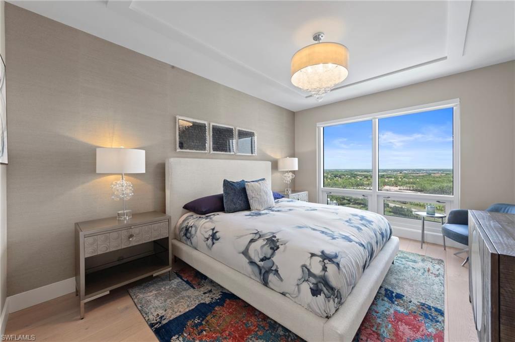 13915 Old Coast Road, Unit 1706 Naples, FL 34110 - Photo 25 of 49 a bedroom with a bed and a large window