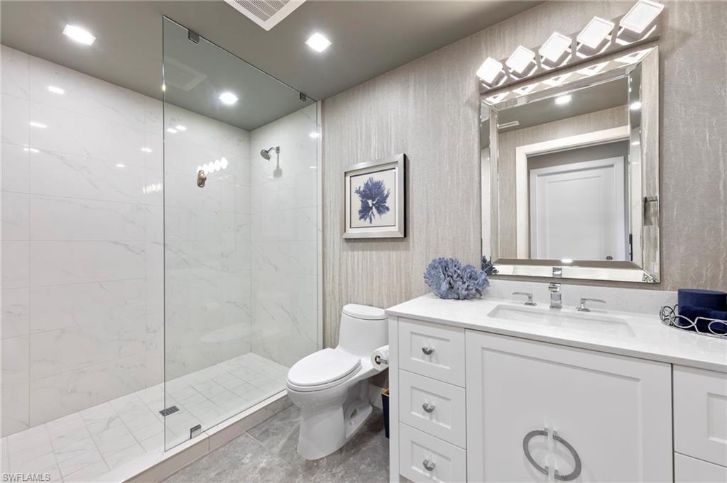 13915 Old Coast Road, Unit 1706 Naples, FL 34110 - Photo 26 of 49 a bathroom with a sink a toilet and shower