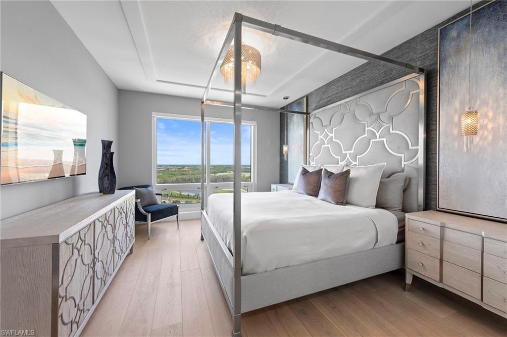 13915 Old Coast Road, Unit 1706 Naples, FL 34110 - Photo 27 of 49 a bedroom with a bed and large window with the outer view