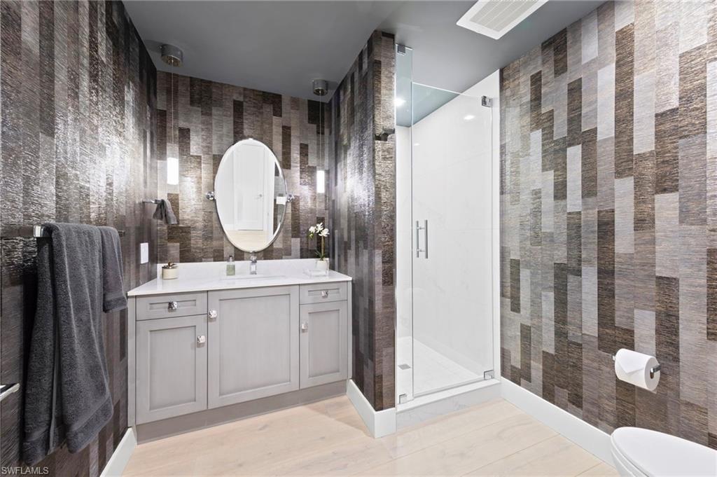 13915 Old Coast Road, Unit 1706 Naples, FL 34110 - Photo 29 of 49 a bathroom with a double vanity sink mirror and shower