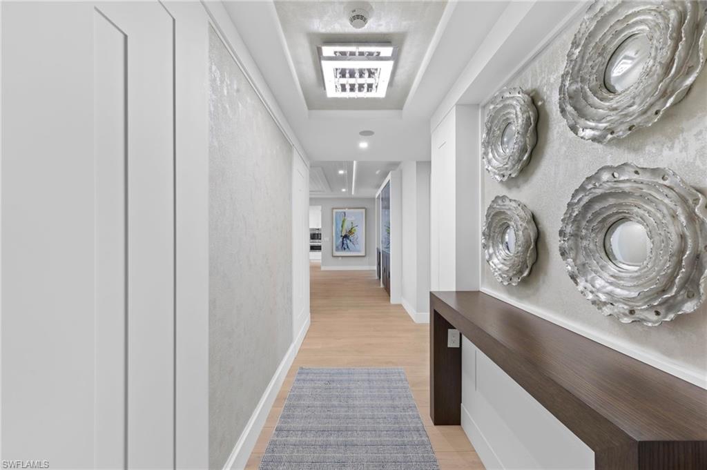 13915 Old Coast Road, Unit 1706 Naples, FL 34110 - Photo 30 of 49 a view of a hallway with washer and dryer