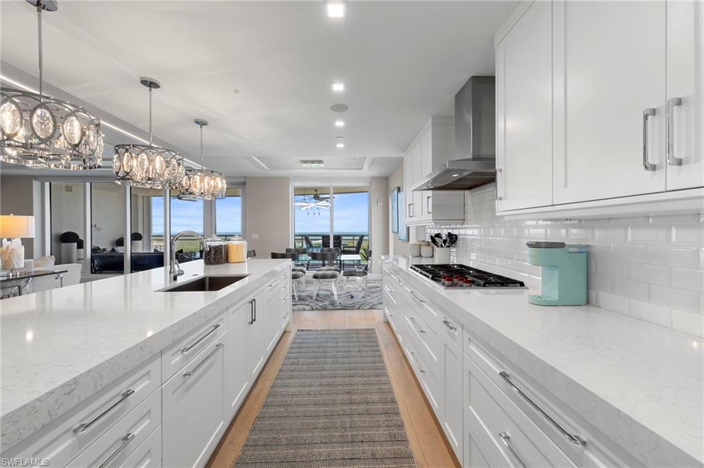 13915 Old Coast Road, Unit 1706 Naples, FL 34110 - Photo 3 of 49 a large kitchen with stainless steel appliances lots of counter space and a sink