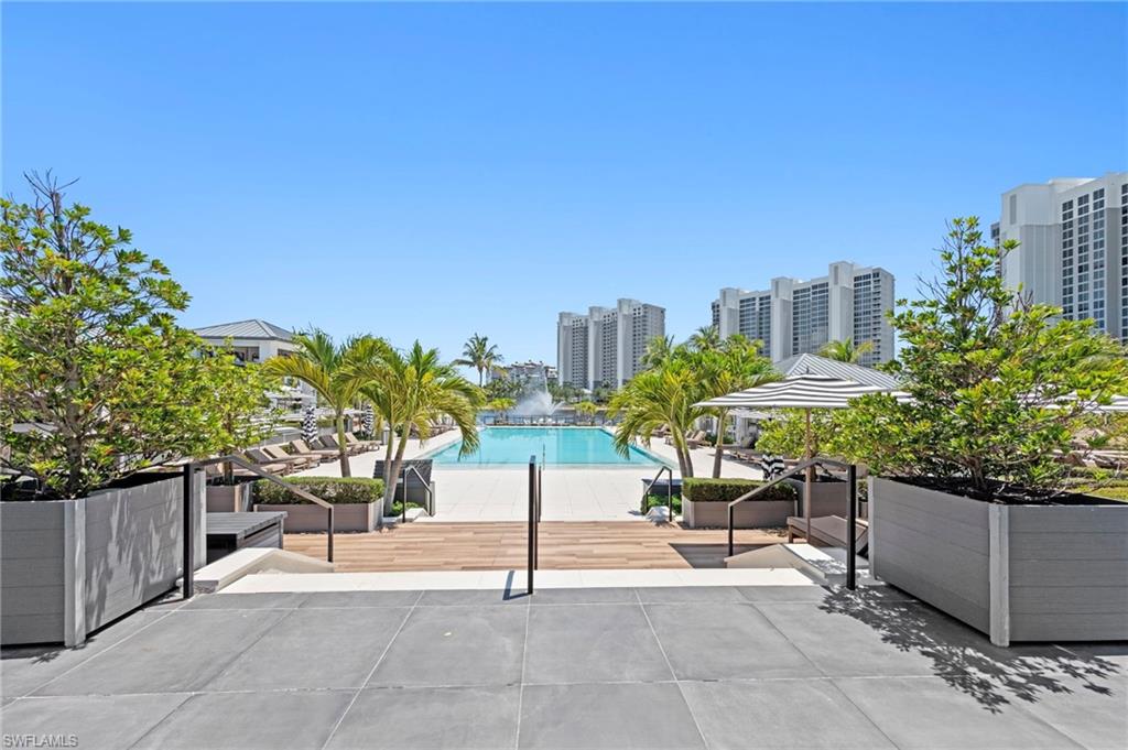 13915 Old Coast Road, Unit 1706 Naples, FL 34110 - Photo 33 of 49 a view of a patio with a table and chairs