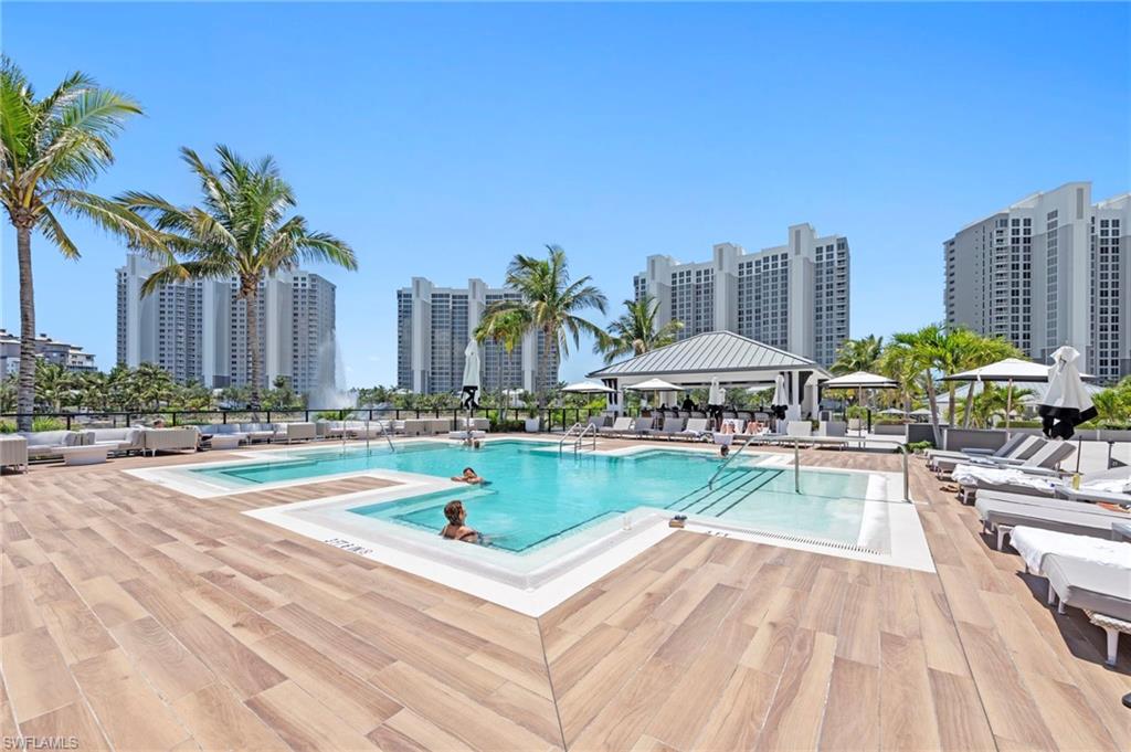 13915 Old Coast Road, Unit 1706 Naples, FL 34110 - Photo 36 of 49 a view of a swimming pool with a lounge chair