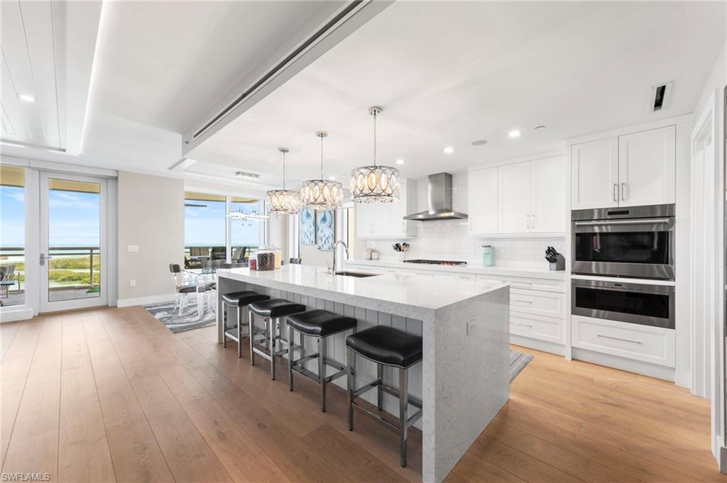 13915 Old Coast Road, Unit 1706 Naples, FL 34110 - Photo 4 of 49 a kitchen with stainless steel appliances a stove a sink a oven and a refrigerator