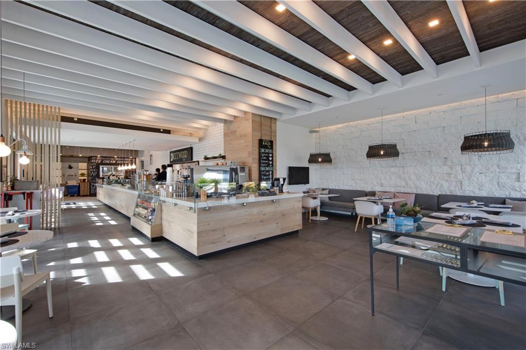 13915 Old Coast Road, Unit 1706 Naples, FL 34110 - Photo 45 of 49 a living room with furniture and a table