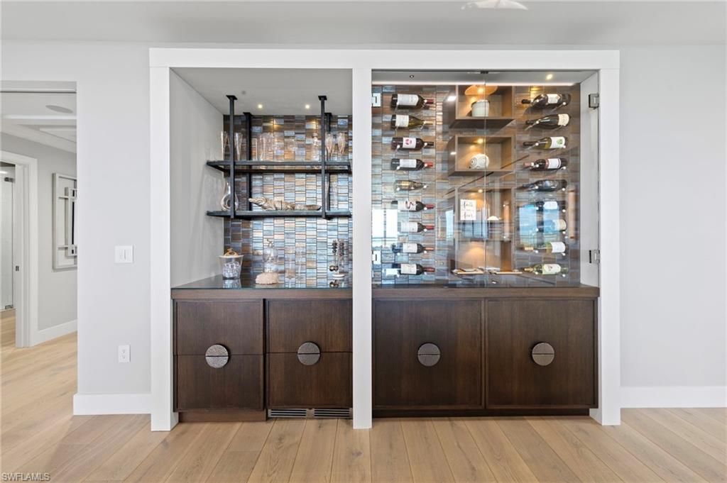 13915 Old Coast Road, Unit 1706 Naples, FL 34110 - Photo 9 of 49 walk in closet with wooden floor